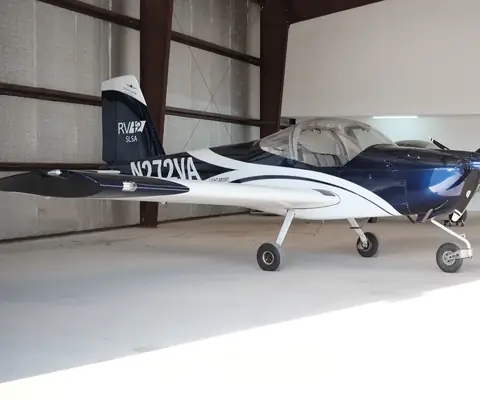 N272VA, a blue and white Van's RV-12 ULS, parked inside a hangar