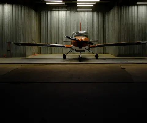 N812EJ seen head-on in the middle of an open hangar
