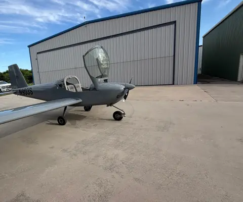 N903S, a Van's RV-12iS, parked on the ramp outside a hangar with the canopy open